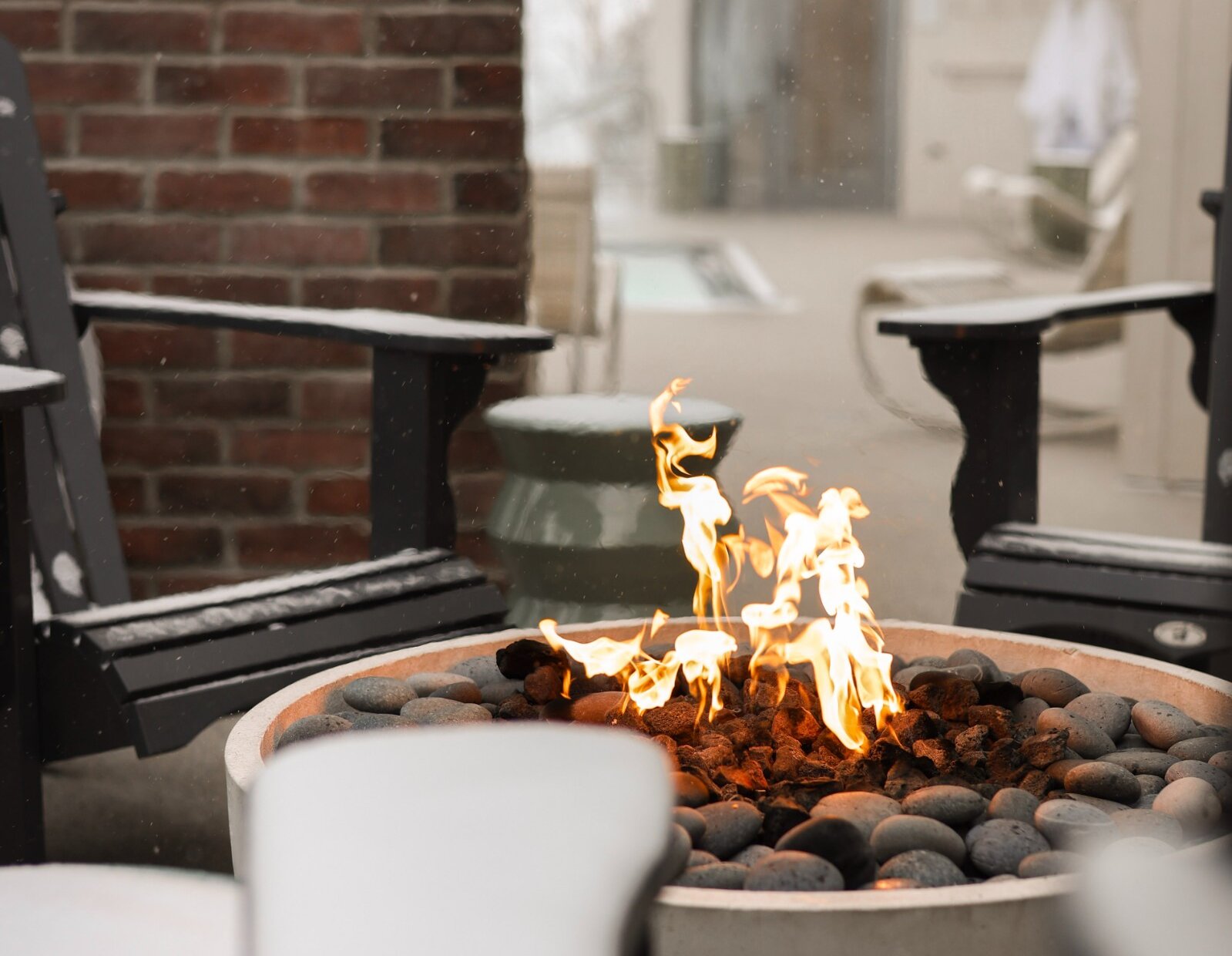 A fireplace with a fire under the snow