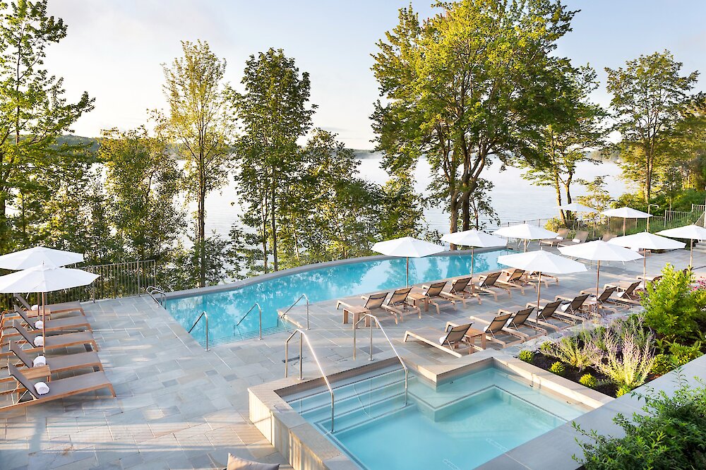 Infinity pool and hot tub overlooking the lake.