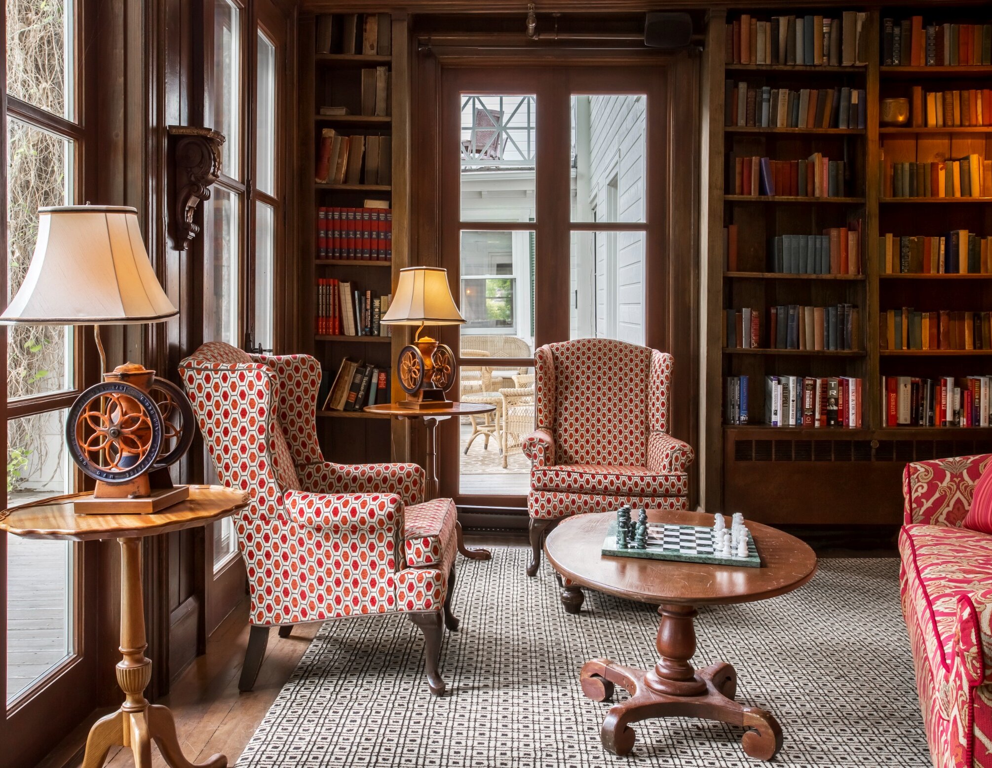 Armchairs by the windows in a library.