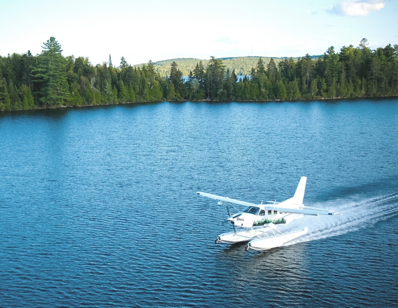 A seaplane landing on a lake.