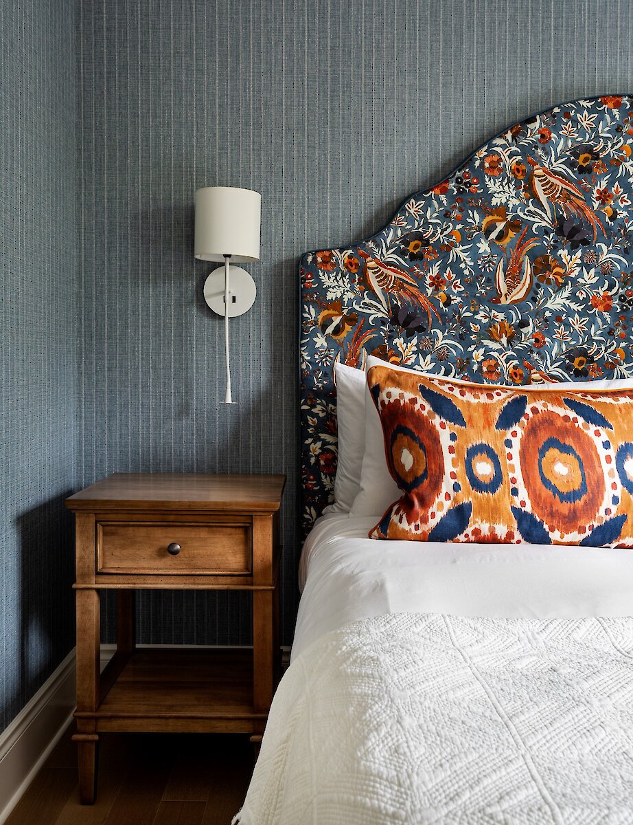 Une chambre à coucher décorée de papier peint bleu