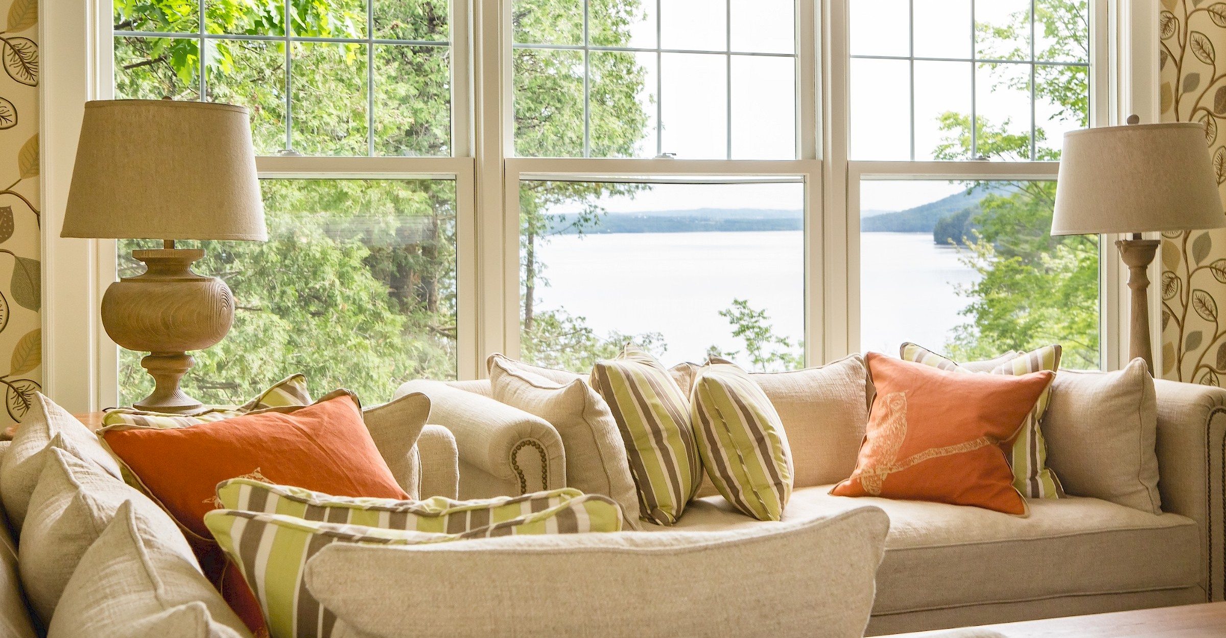 Living room with sofa and view of the lake through the windows