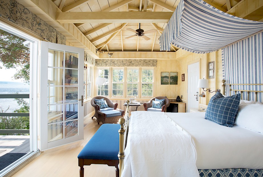 Lakeside cottage with a king-size bed and wood panelling