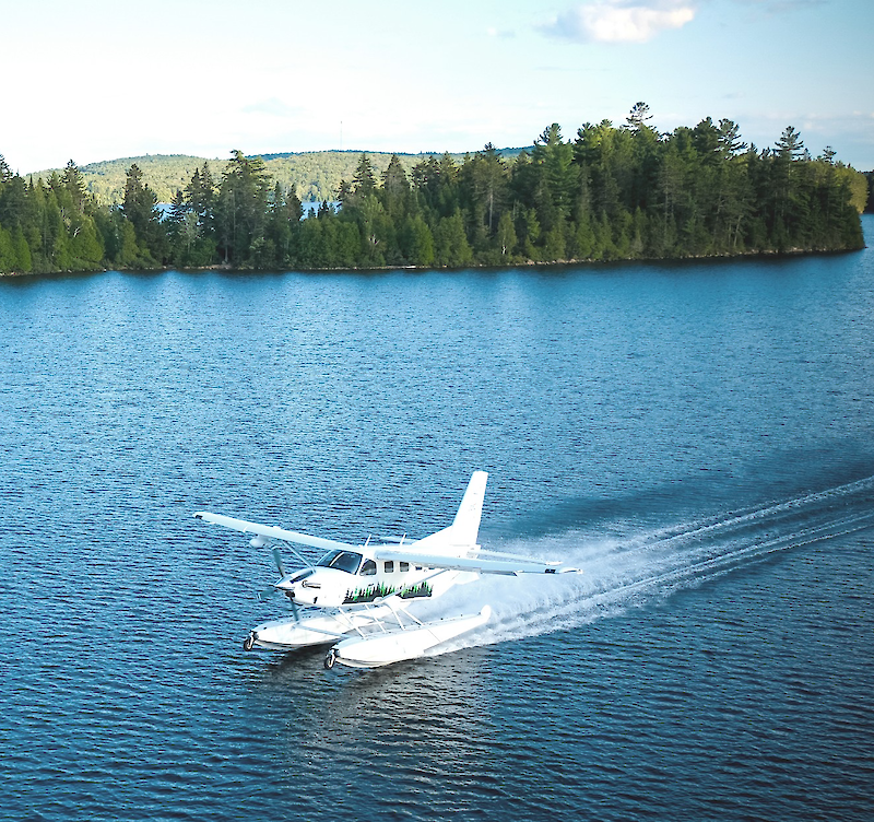 A seaplane landing on a lake