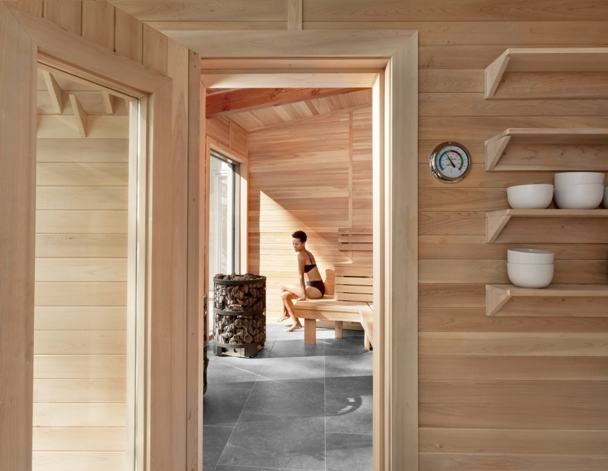 A woman relaxes in a sauna