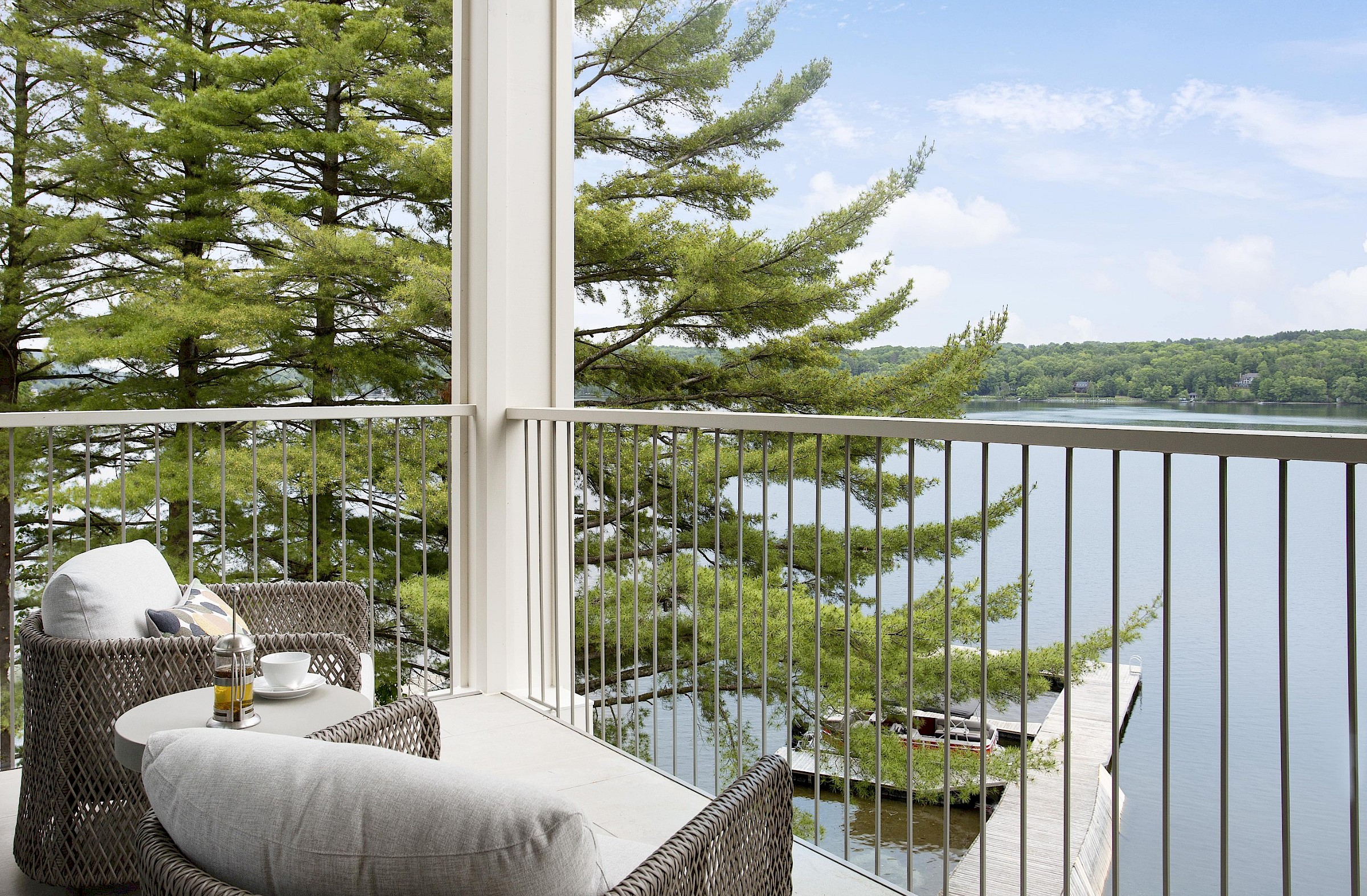 Balcony with couches and panoramic view of the lake