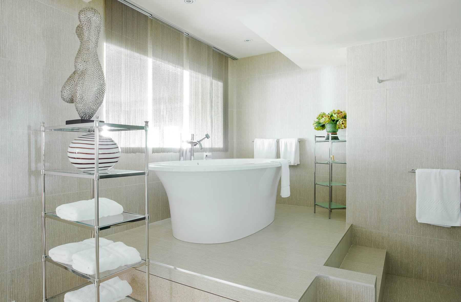 Bathtub in the middle of a bright and spacious room