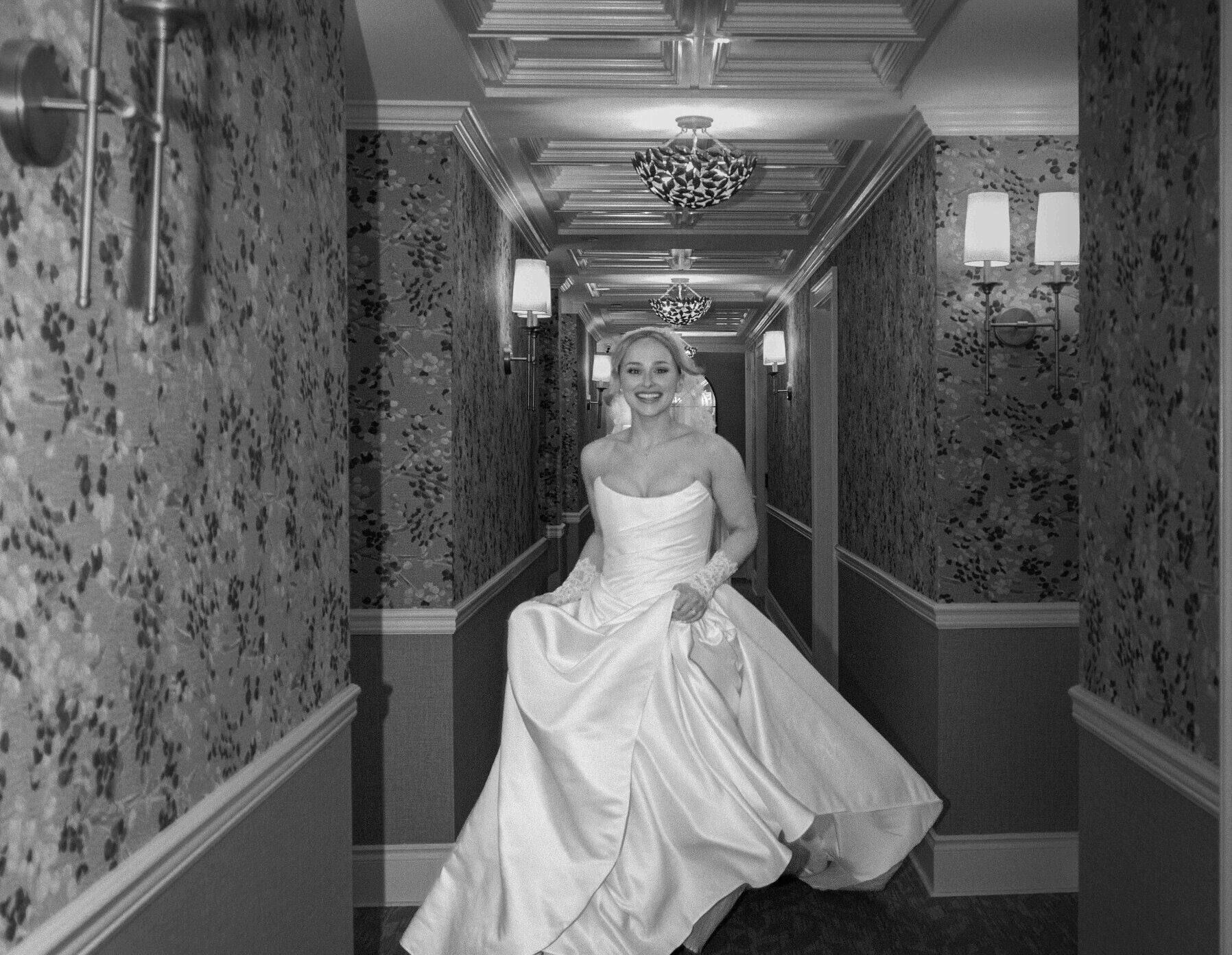 Bride walking through a hallway in her wedding dress.