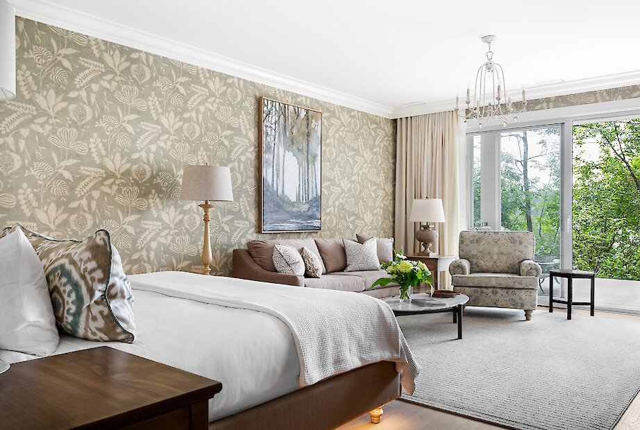 A bright living room with a private balcony and stunning lake views.