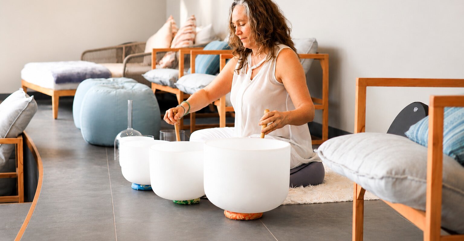 A woman leading a sound bath activity