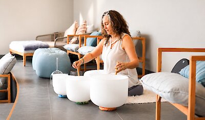 A woman leading a sound bath activity