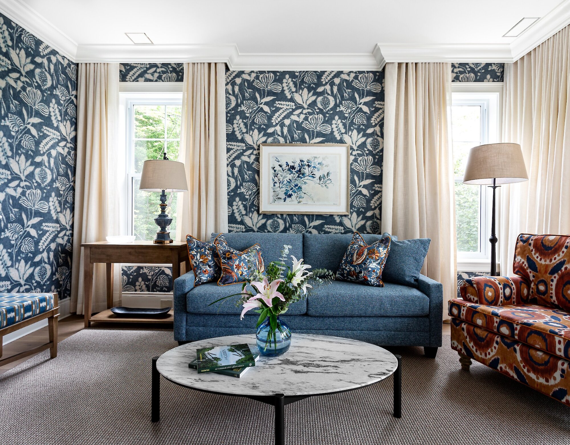 A traditionally styled living room with blue wallpaper