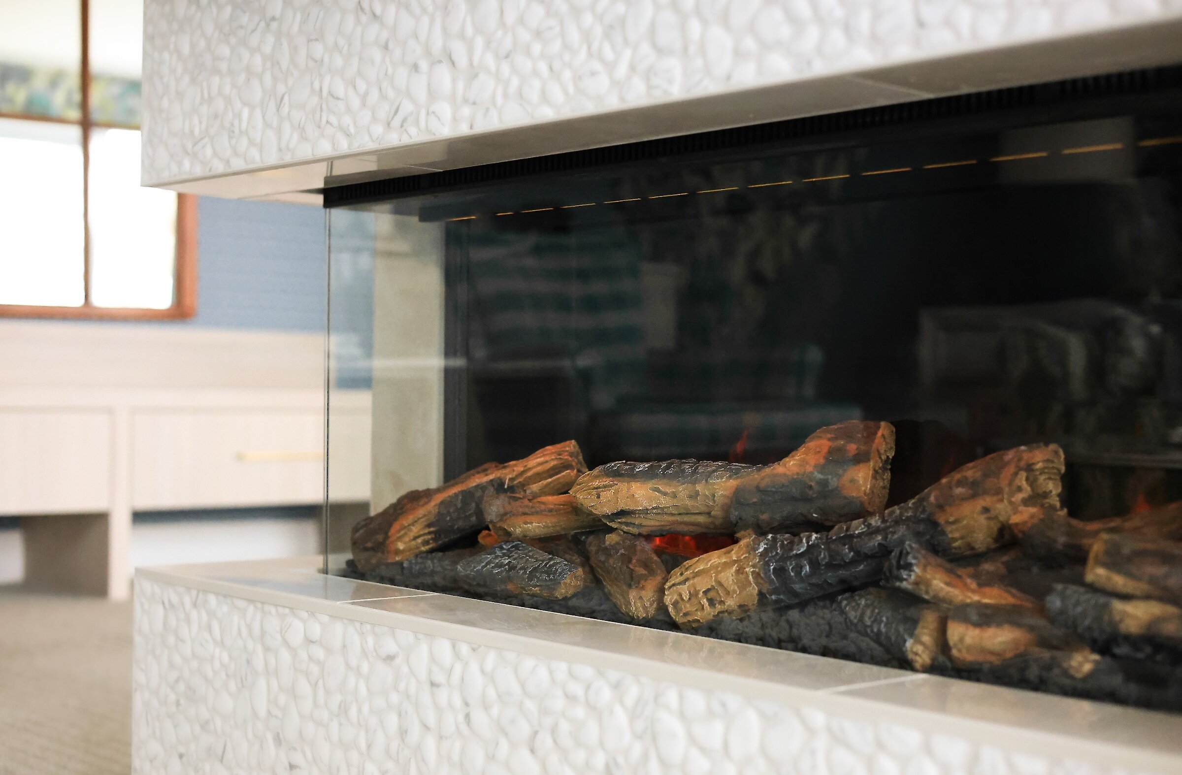 Foyer contemporain intégré, apportant chaleur et ambiance à l’espace de vie de la suite.