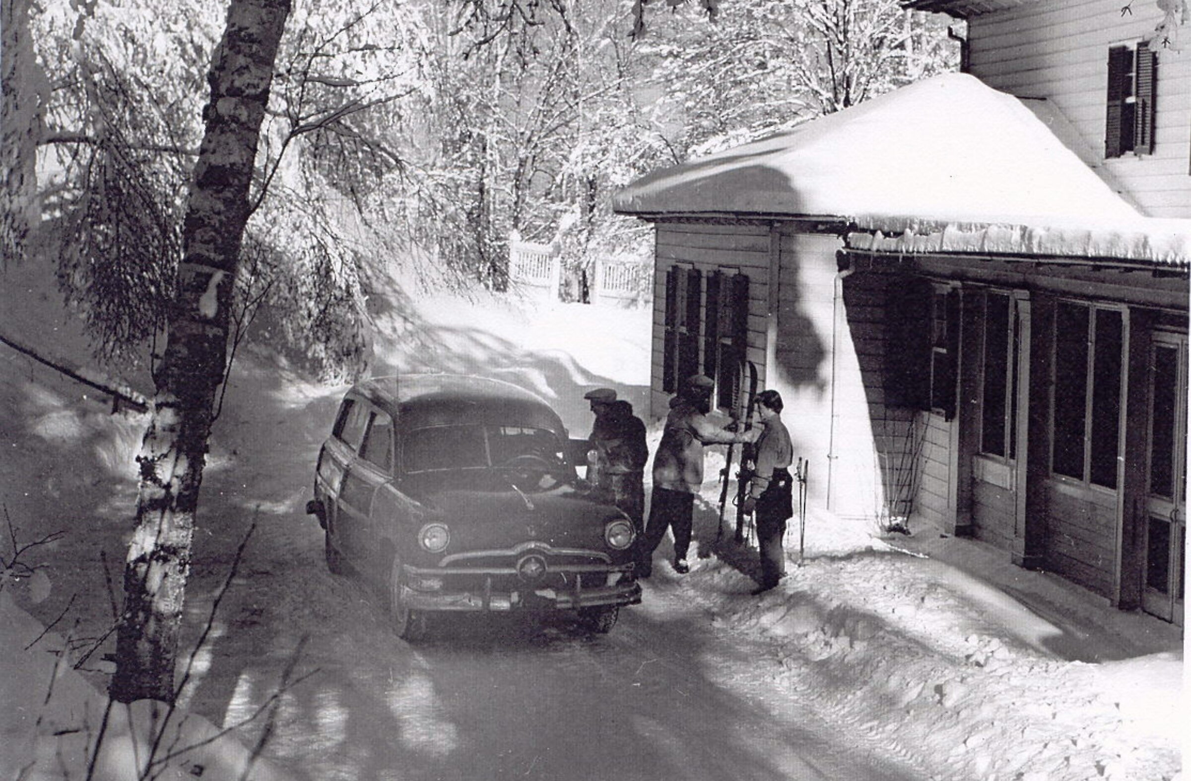 A car in the snow in front of the hotel