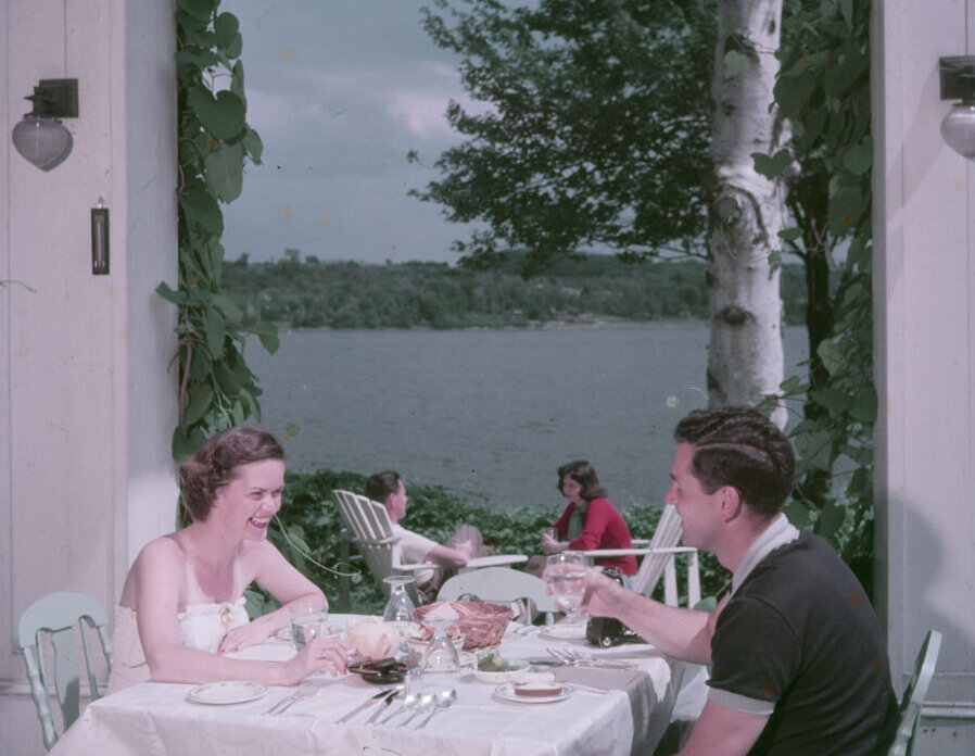 A couple eating by the lake.