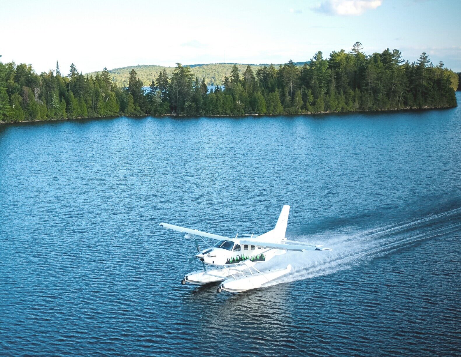 A seaplane flying over a lake
